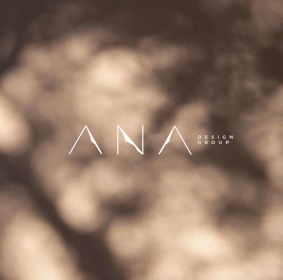 ANA Design Group logo in dappled leaf shadow