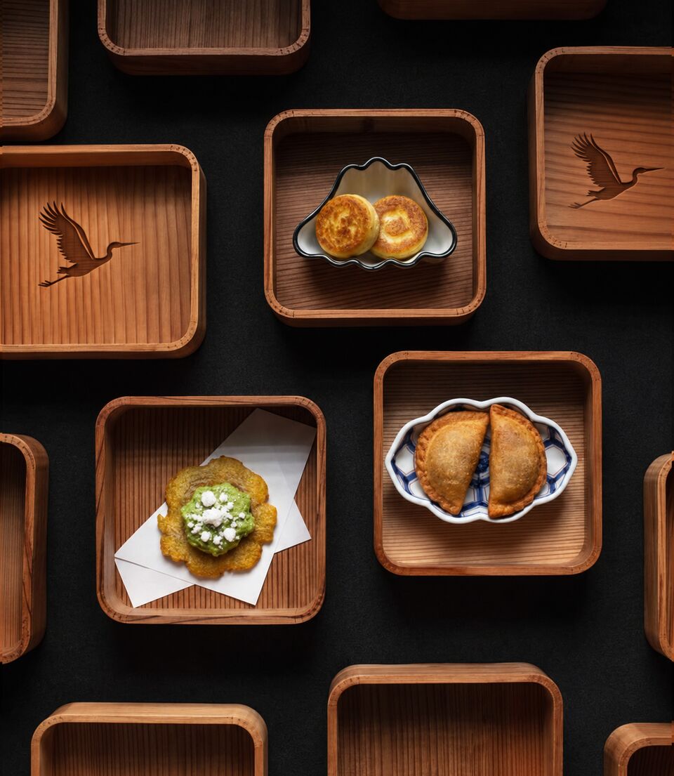 Wooden trays engraved with cranes, holding small plates