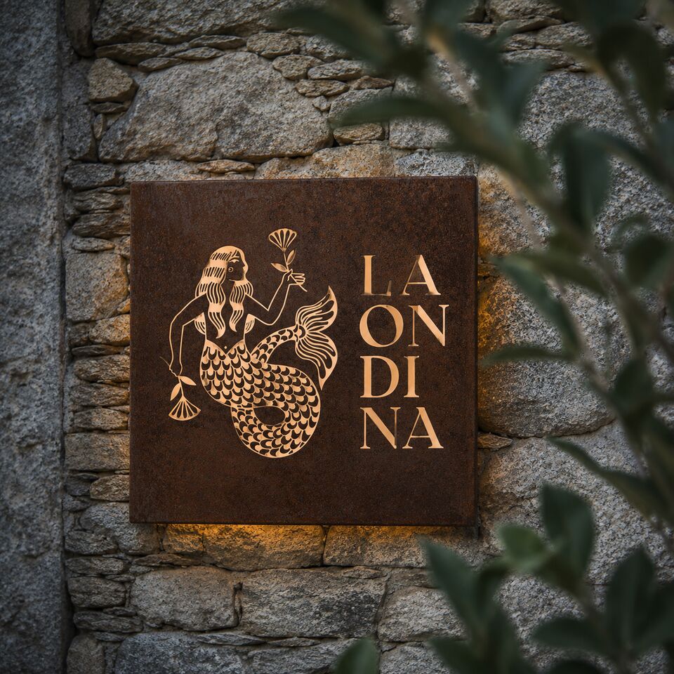 La Ondina mermaid sign on a stone wall
